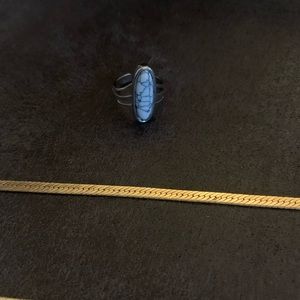 1 gold necklace, 2 gold bracelets, & 1 silver ring with black and white stone.